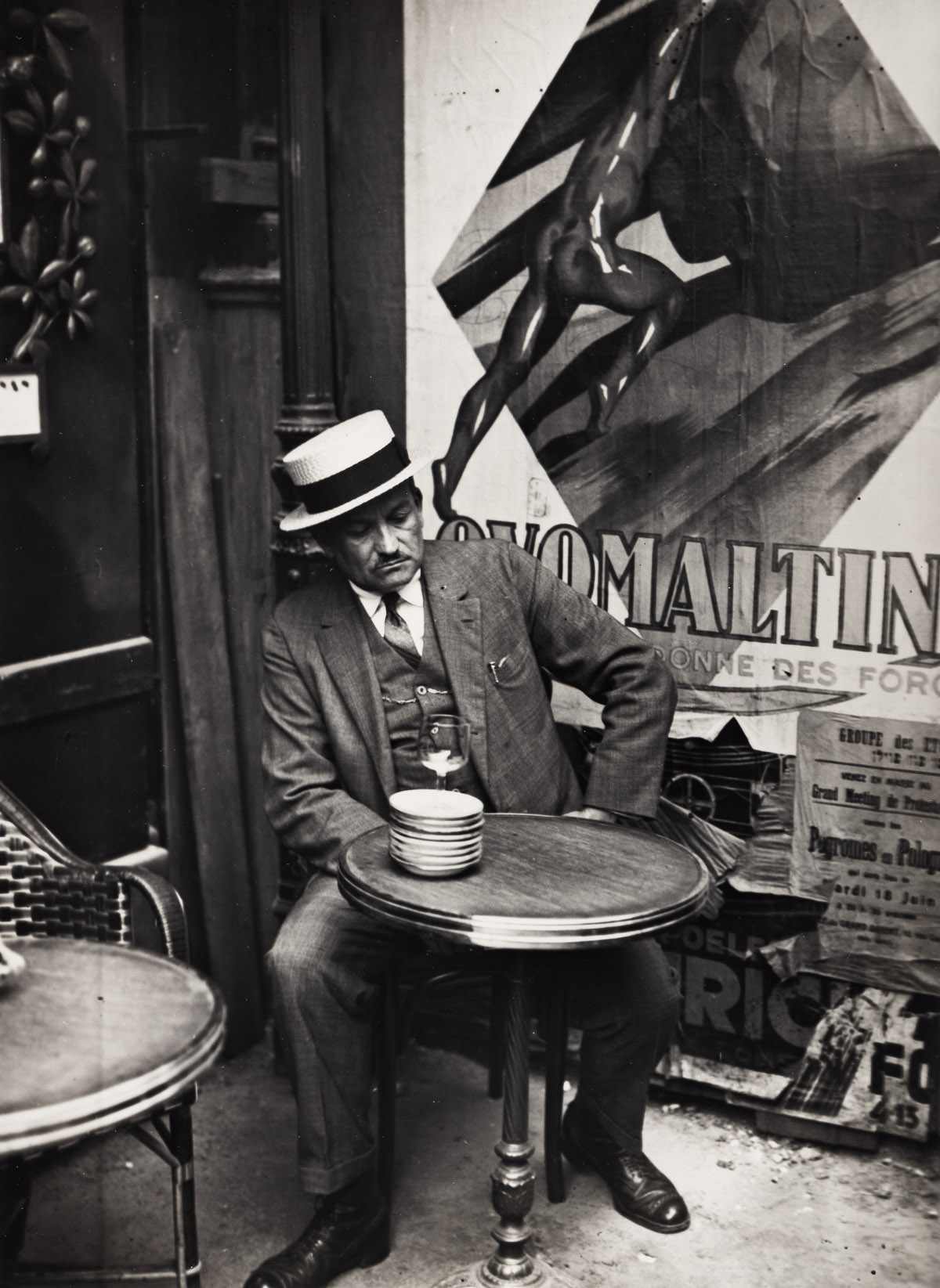 ANDRÉ KERTÉSZ (1894-1985) At a Café, Paris.